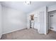 The bedroom features carpet flooring, closet with built-in shelving, and white-painted walls at 3806 S Yosemite St, Denver, CO 80237