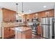Kitchen features granite countertops, stainless appliances, tile backsplash and island at 3806 S Yosemite St, Denver, CO 80237