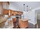 Kitchen features granite countertops, stainless steel appliances, and a center island at 3806 S Yosemite St, Denver, CO 80237