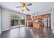 Modern kitchen with stainless steel appliances, wood cabinets, and a sliding glass door to the patio at 3806 S Yosemite St, Denver, CO 80237