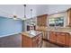 Open kitchen boasts island, sliding glass door, and ample countertop space at 3806 S Yosemite St, Denver, CO 80237
