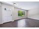 Bright living area features hardwood floors and a large window offering views of the outdoors at 3806 S Yosemite St, Denver, CO 80237