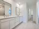 Bright bathroom with double sinks, quartz counters, and modern tile flooring at 595 Twilight St, Erie, CO 80516