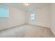 A light filled bedroom with neutral carpet and windows at 595 Twilight St, Erie, CO 80516