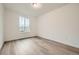 A bright bedroom with light hardwood floors and a window at 595 Twilight St, Erie, CO 80516