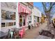 Exterior view of a storefront with outdoor seating and a vibrant pink and white awning at 595 Twilight St, Erie, CO 80516