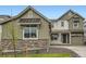 Charming two-story home featuring stone accents, a dark door, and a well-maintained front yard at 595 Twilight St, Erie, CO 80516