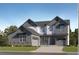 New construction home boasts modern architectural design, a manicured lawn, and a two-car garage at 595 Twilight St, Erie, CO 80516