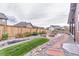 Backyard with a fire pit, rock landscaping, and lush green grass at 15804 Elizabeth Cir, Brighton, CO 80602