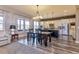 Open-concept dining area with a view of the gourmet kitchen and living room at 15804 Elizabeth Cir, Brighton, CO 80602