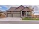 Charming stone home with a three-car garage and inviting front porch at 15804 Elizabeth Cir, Brighton, CO 80602