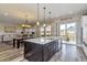 Open concept kitchen with island, stainless appliances, and view to living area at 15804 Elizabeth Cir, Brighton, CO 80602
