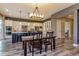 Open kitchen with white cabinets, dark island, and dining area at 15804 Elizabeth Cir, Brighton, CO 80602