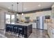 Kitchen island with stainless steel appliances, granite countertops, and pendant lighting at 15804 Elizabeth Cir, Brighton, CO 80602