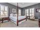Bright main bedroom featuring dark wood trim, carpet, and plantation shutters at 15804 Elizabeth Cir, Brighton, CO 80602