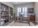 Well-lit home office featuring a built-in bookshelf and stylish decor at 15804 Elizabeth Cir, Brighton, CO 80602
