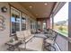 Covered porch with outdoor furniture, area rug, and view of the yard at 15804 Elizabeth Cir, Brighton, CO 80602