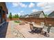 Beautiful backyard with a stone patio, fire pit, and landscaped areas, perfect for outdoor gatherings at 15804 Elizabeth E Cir, Thornton, CO 80602