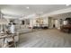 Spacious finished basement with a large sectional sofa, bar, and dining area at 15804 Elizabeth E Cir, Thornton, CO 80602