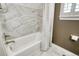 Modern bathroom featuring a white tub, tiled walls, and contemporary fixtures, creating a relaxing and spa-like atmosphere at 15804 Elizabeth E Cir, Thornton, CO 80602