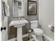 Bathroom featuring a pedestal sink and a toilet with gray walls and a picture hanging above the toilet at 15804 Elizabeth E Cir, Thornton, CO 80602