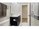 Modern bathroom with dark cabinets, white sink, and a neutral color palette at 15804 Elizabeth E Cir, Thornton, CO 80602