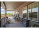 Comfortable covered patio with plenty of seating and an ornate wall decoration above a fireplace at 15804 Elizabeth E Cir, Thornton, CO 80602