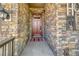 Charming front entrance featuring stone accents and a stylish door with decorative glass, exuding curb appeal at 15804 Elizabeth E Cir, Thornton, CO 80602