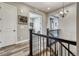 Upstairs hallway featuring wood floors, black metal railing, white doors and views into adjacent rooms at 15804 Elizabeth E Cir, Thornton, CO 80602