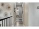 Hallway with decorative wall hangings, neutral colored walls, and hardwood floors at 15804 Elizabeth E Cir, Thornton, CO 80602
