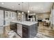 Open kitchen featuring a large island with a dishwasher and a seamless flow into the living room at 15804 Elizabeth E Cir, Thornton, CO 80602