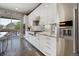 Well-equipped kitchen with stainless steel appliances, white cabinets, and access to the outdoor space at 15804 Elizabeth E Cir, Thornton, CO 80602