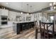 Kitchen island with seating, stylish pendant lighting, and white cabinets at 15804 Elizabeth E Cir, Thornton, CO 80602