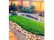 Beautifully landscaped backyard with stones and green lawn at 15804 Elizabeth E Cir, Thornton, CO 80602