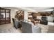 Finished basement living area with plush seating, bar access, and neutral decor at 15804 Elizabeth E Cir, Thornton, CO 80602