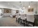 Finished basement with a bar, sofa, and modern lighting fixtures at 15804 Elizabeth E Cir, Thornton, CO 80602