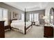 Luxurious main bedroom with tray ceilings, neutral walls, carpet floors and stylish furnishings at 15804 Elizabeth E Cir, Thornton, CO 80602