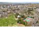 Stunning aerial view featuring green park space, tennis courts, and the Denver skyline in the background at 2475 S Adams St, Denver, CO 80210