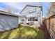 Beautiful backyard features a stone patio, comfortable seating, a fire pit table, and a grassy lawn at 2475 S Adams St, Denver, CO 80210