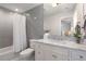 Bright bathroom features a marble countertop, grey subway tile, and shower with tub at 2475 S Adams St, Denver, CO 80210