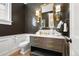 Powder room features a vanity with marble countertop and a decorative mirror above at 2475 S Adams St, Denver, CO 80210