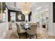 Elegant dining room with modern chandelier, large table, and comfortable seating, next to the living room at 2475 S Adams St, Denver, CO 80210