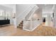 Bright foyer boasts wood floors, staircase, and tasteful decor, creating a welcoming ambiance at 2475 S Adams St, Denver, CO 80210