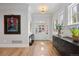 Bright foyer featuring hardwood floors, modern decor, and a view of the exterior through a glass-paneled front door at 2475 S Adams St, Denver, CO 80210