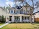 Charming gray two-story home with a welcoming front porch and well-manicured lawn at 2475 S Adams St, Denver, CO 80210