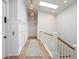 Bright hallway featuring wainscoting detail, a lift, wood floors and modern lighting at 2475 S Adams St, Denver, CO 80210