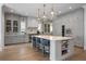 Spacious kitchen with gray cabinets, marble countertops, large island, and stainless steel appliances at 2475 S Adams St, Denver, CO 80210