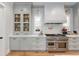 Kitchen features a stainless steel range, white subway tile backsplash, and custom gray cabinetry at 2475 S Adams St, Denver, CO 80210