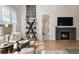 Bright and airy living room boasts a fireplace, built-in shelving, and neutral decor at 2475 S Adams St, Denver, CO 80210