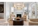 Cozy living room features a fireplace, neutral furniture, large windows, and wood floors at 2475 S Adams St, Denver, CO 80210